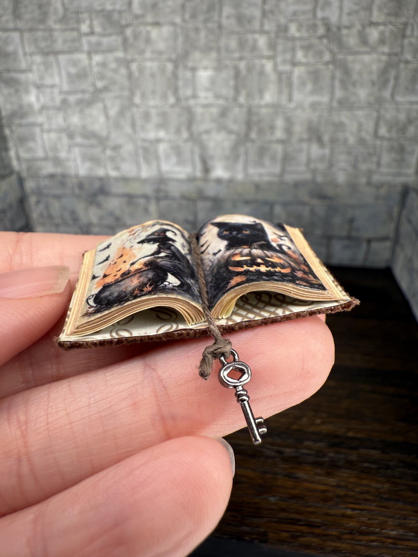 Witch stirring cauldron with black cat on jack-o’-lantern Open Book - 1:12 Scale