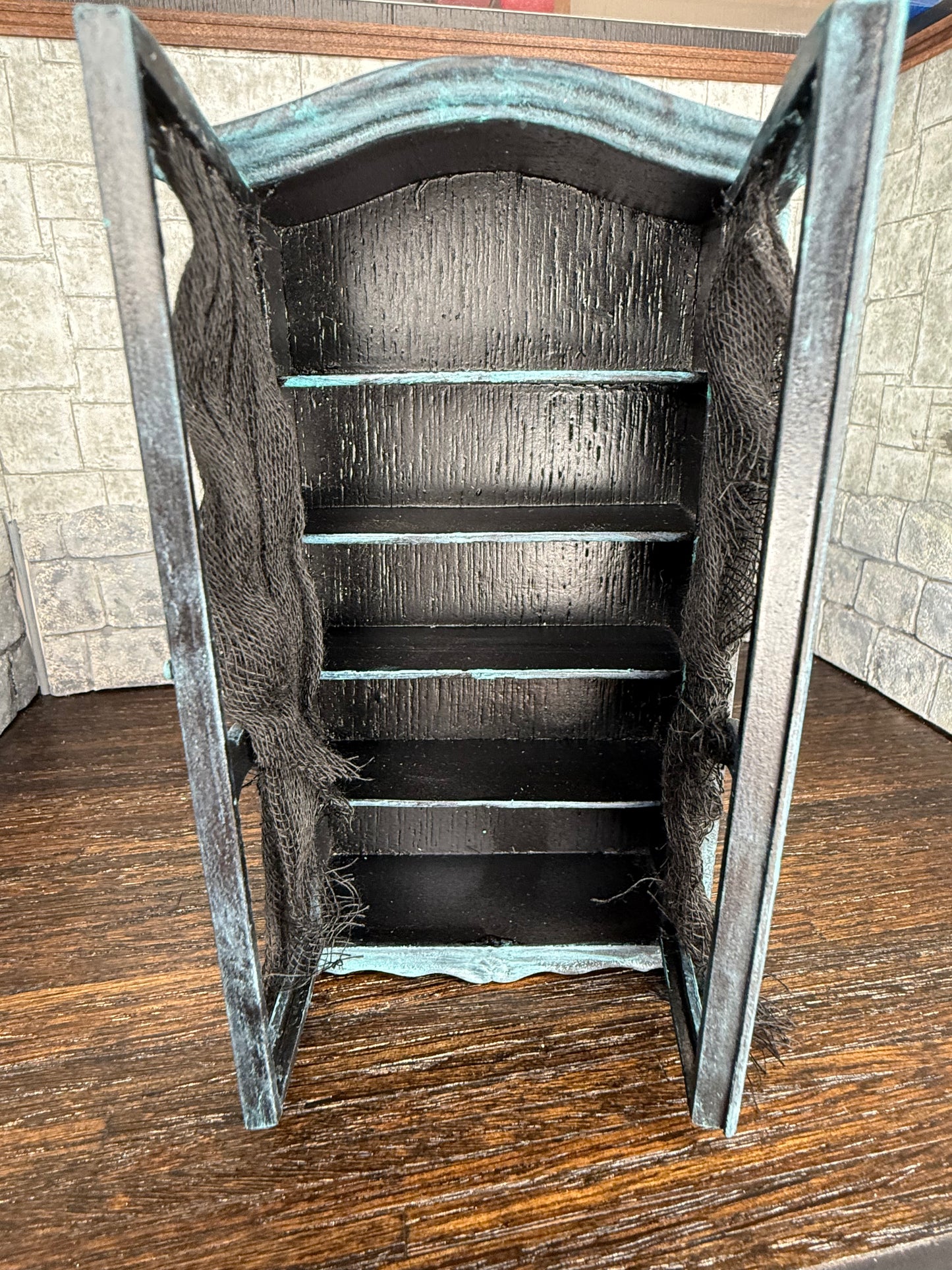 Empty Tarnished and Black Armoire with Skull Front Feet and Black Net Curtains