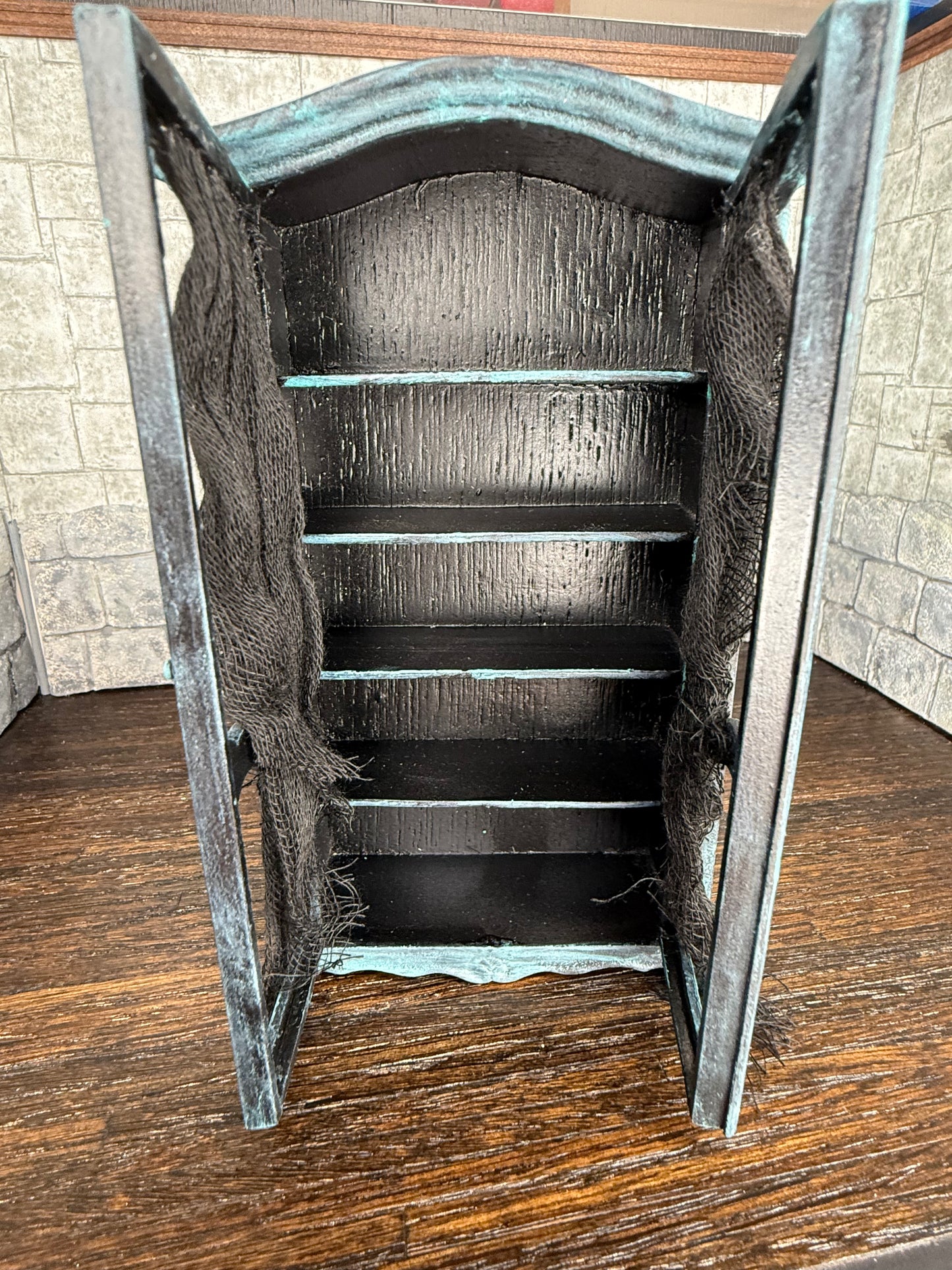 Empty Tarnished and Black Armoire with Skull Front Feet and Black Net Curtains